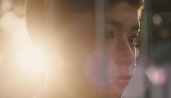 Thumbnail of a video showing the face of a young kid looking to the right, illuminated from behind by the sun.
