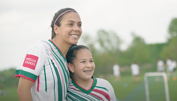 Mexican National Team player and child smiling at camara